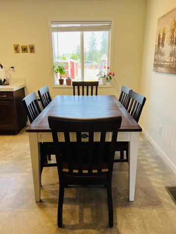 a view of a dining room with furniture window and outside view
