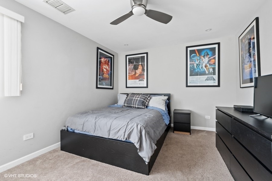 378 Milford Road Deerfield, IL 60015 - Photo 12 of 22 a bedroom with a bed and a chandelier