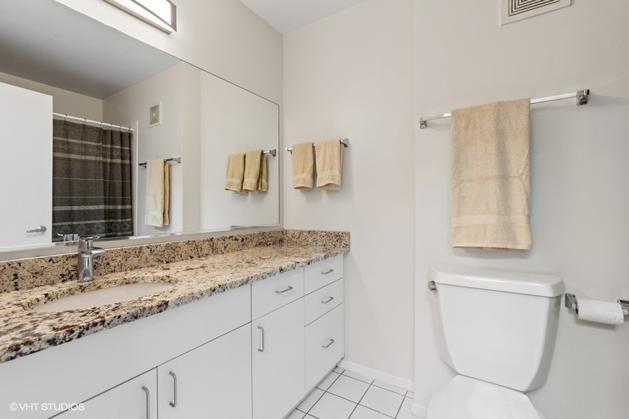 378 Milford Road Deerfield, IL 60015 - Photo 14 of 22 a bathroom with a toilet sink and mirror