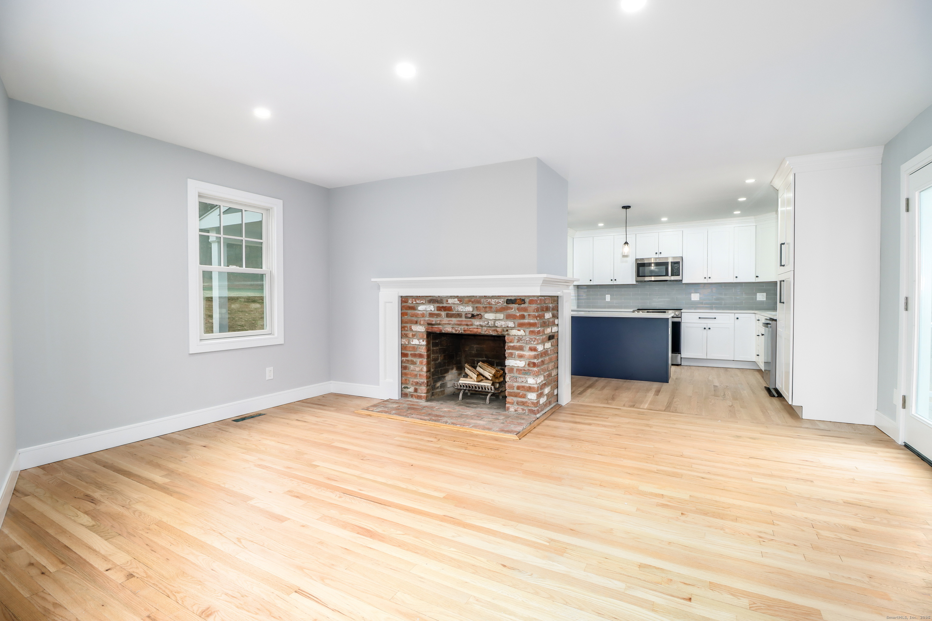 5 Antler Pine Road Newtown, CT 06482 - Photo 14 of 38 a view of an empty room with a fireplace and a window