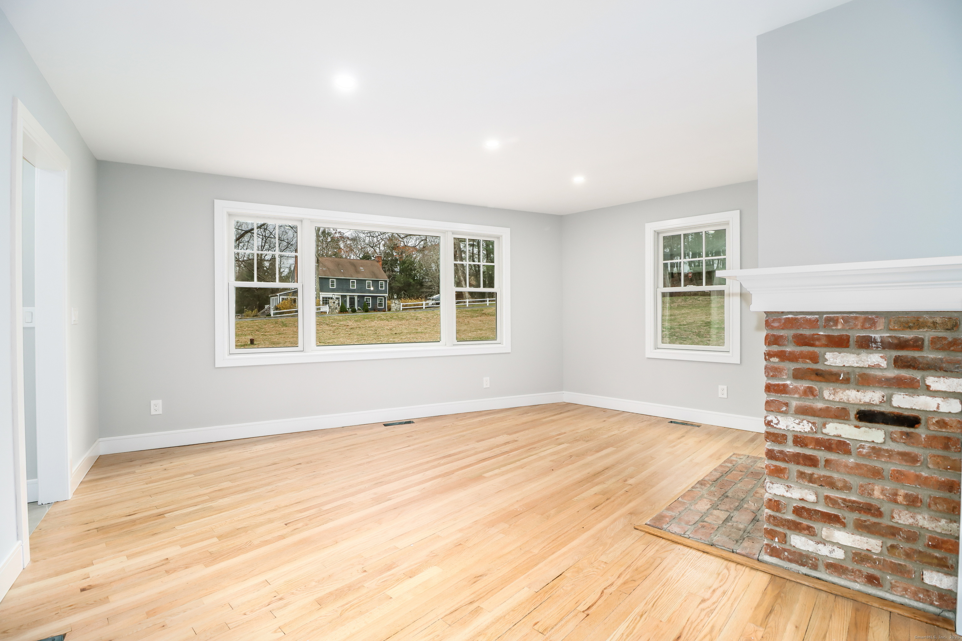 5 Antler Pine Road Newtown, CT 06482 - Photo 16 of 38 a view of an empty room with wooden floor and a window