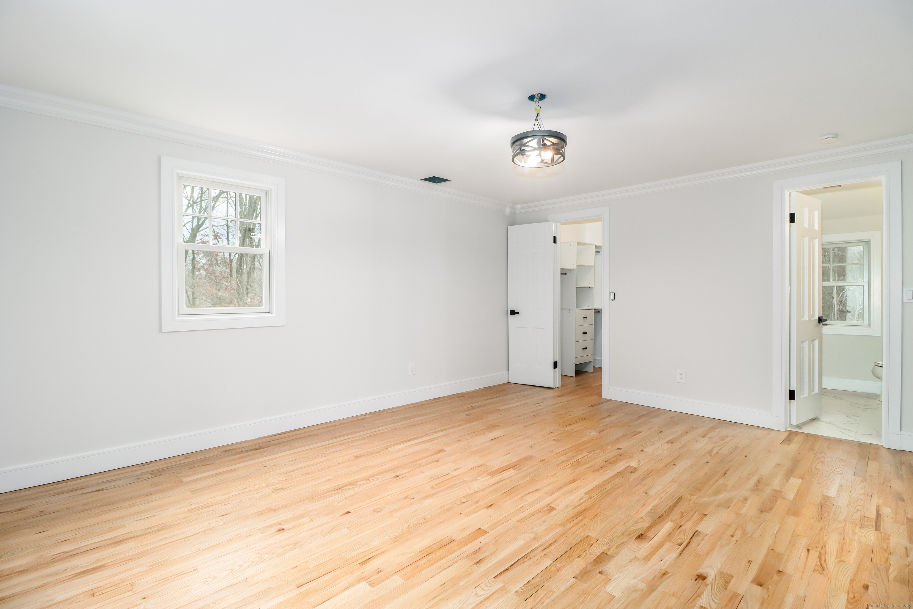 5 Antler Pine Road Newtown, CT 06482 - Photo 22 of 38 a view of an empty room with wooden floor and a window