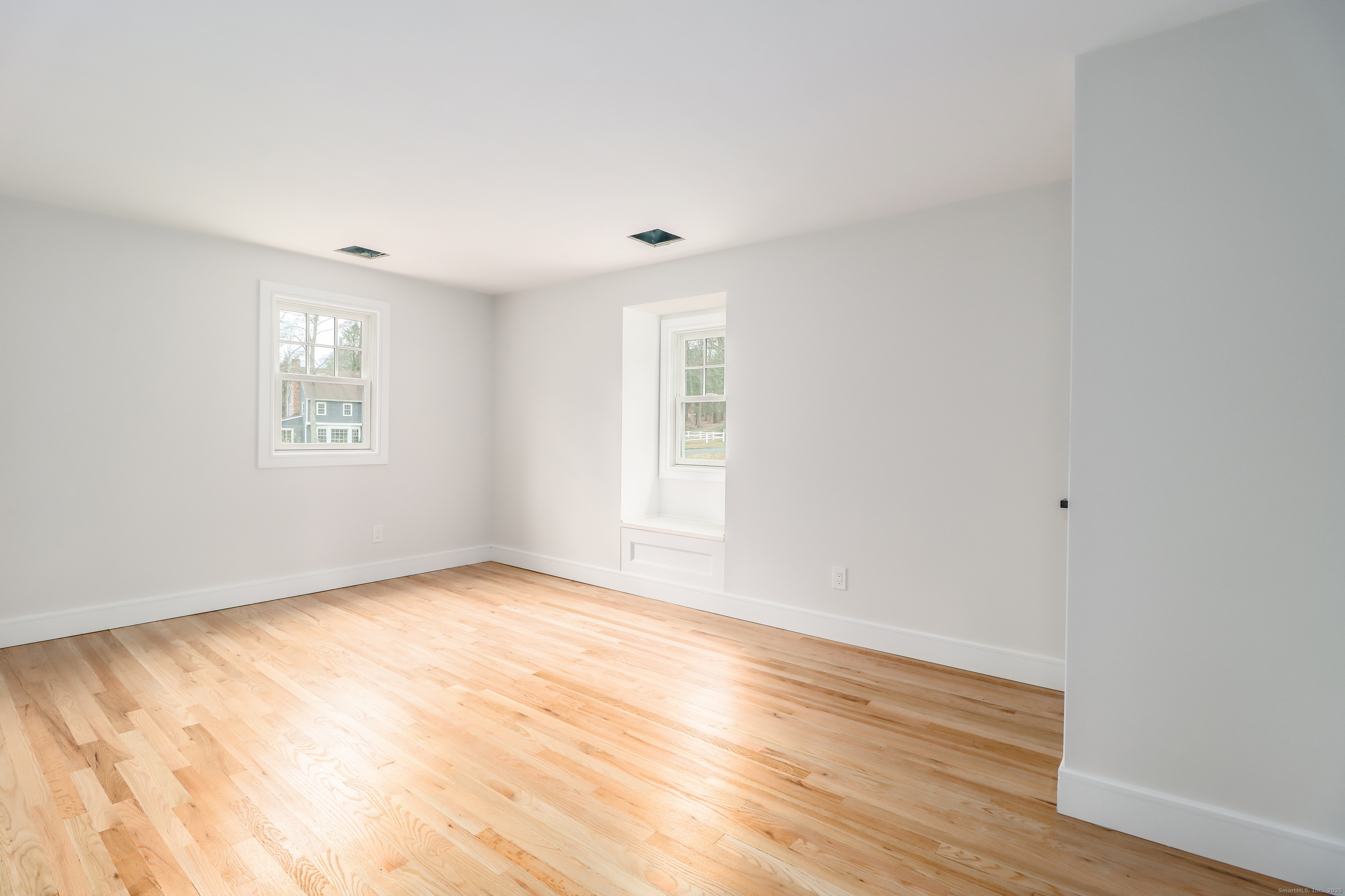 5 Antler Pine Road Newtown, CT 06482 - Photo 24 of 38 a view of an empty room with wooden floor and a window