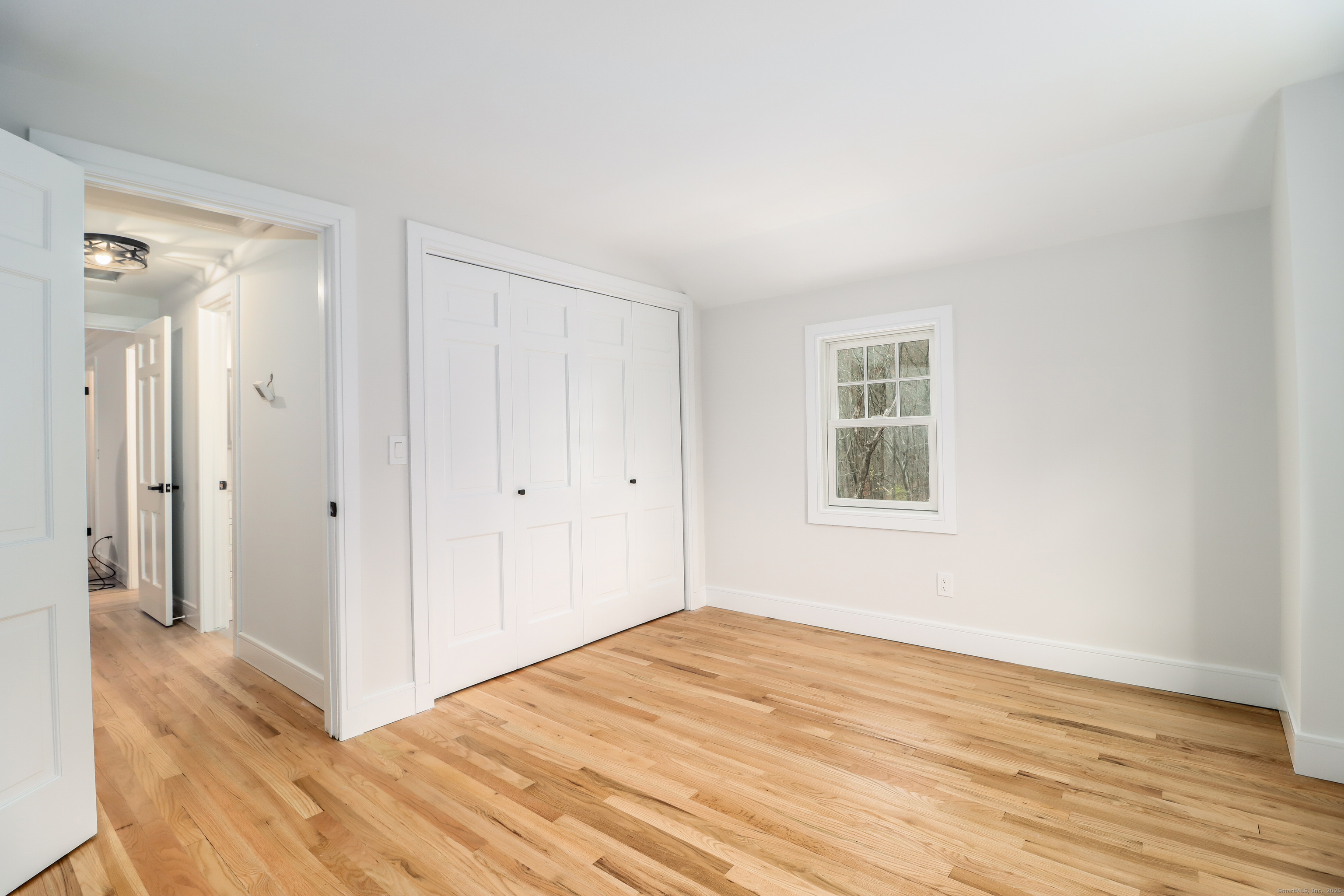 5 Antler Pine Road Newtown, CT 06482 - Photo 27 of 38 a big room with wooden floor and windows