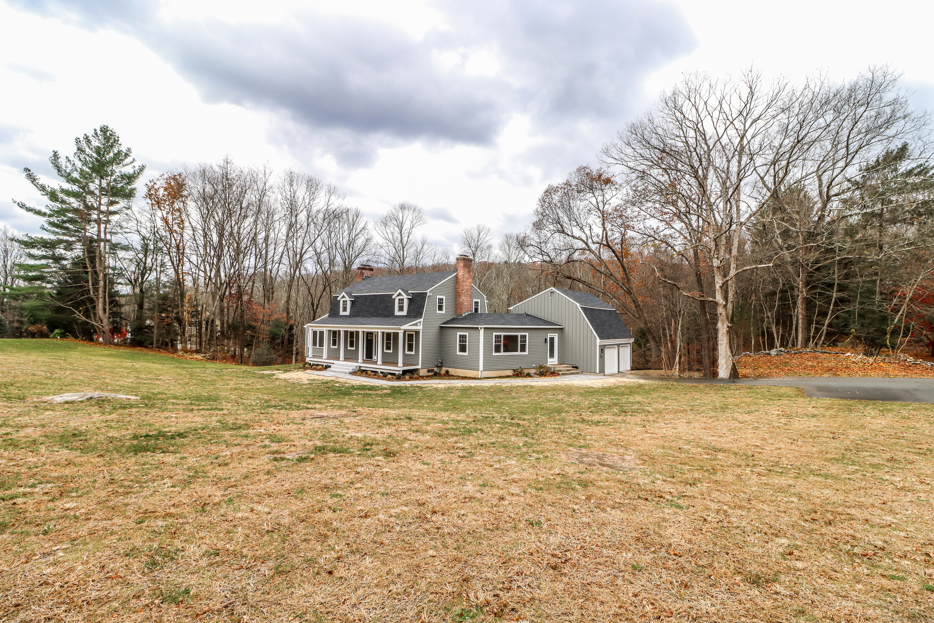 5 Antler Pine Road Newtown, CT 06482 - Photo 32 of 38 a front view of a house with a yard