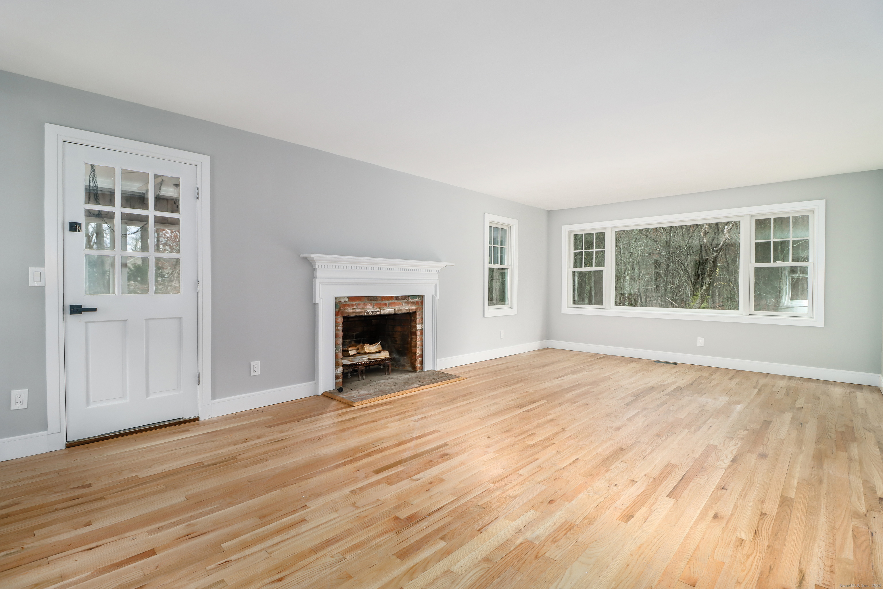 5 Antler Pine Road Newtown, CT 06482 - Photo 6 of 38 a view of empty room with wooden floor and fireplace