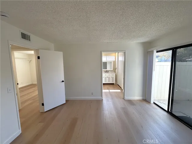 an empty room with wooden floor and a window