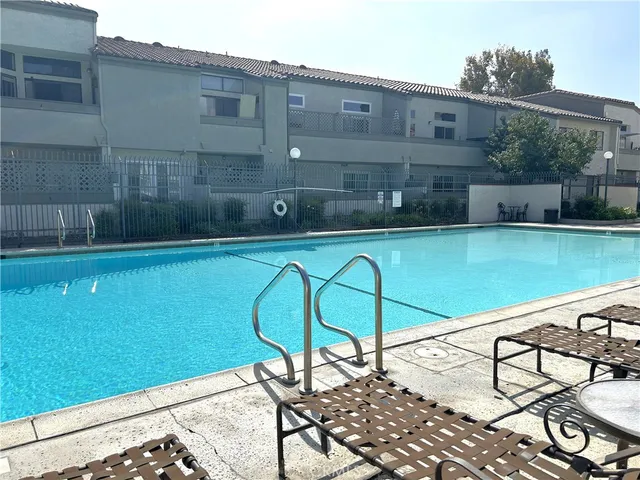 a view of a chair and tables in the patio