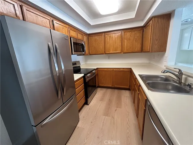 a kitchen with refrigerator a sink and cabinets