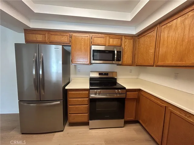 a kitchen with a refrigerator stove and microwave