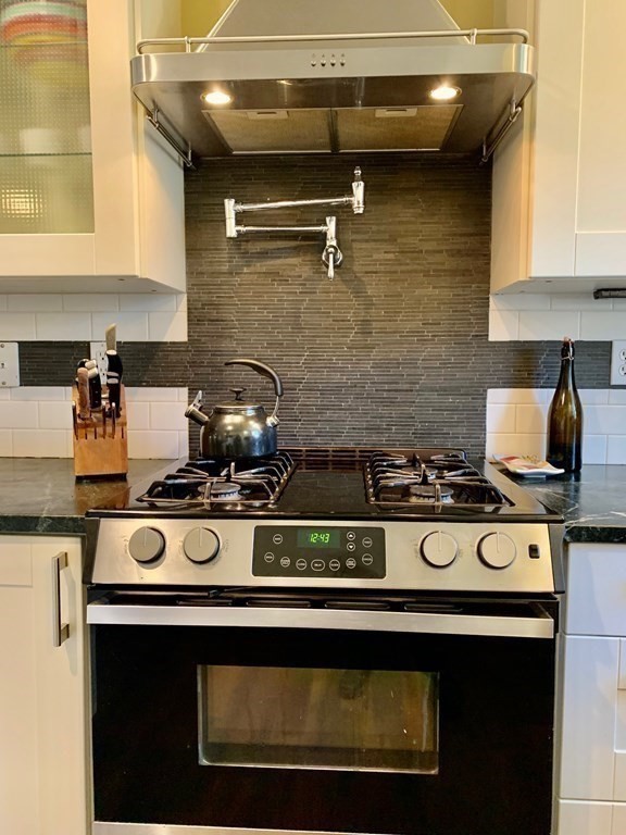 696 Florence Road Northampton, MA 01062 - Photo 12 of 35 a stove top oven sitting inside of a kitchen