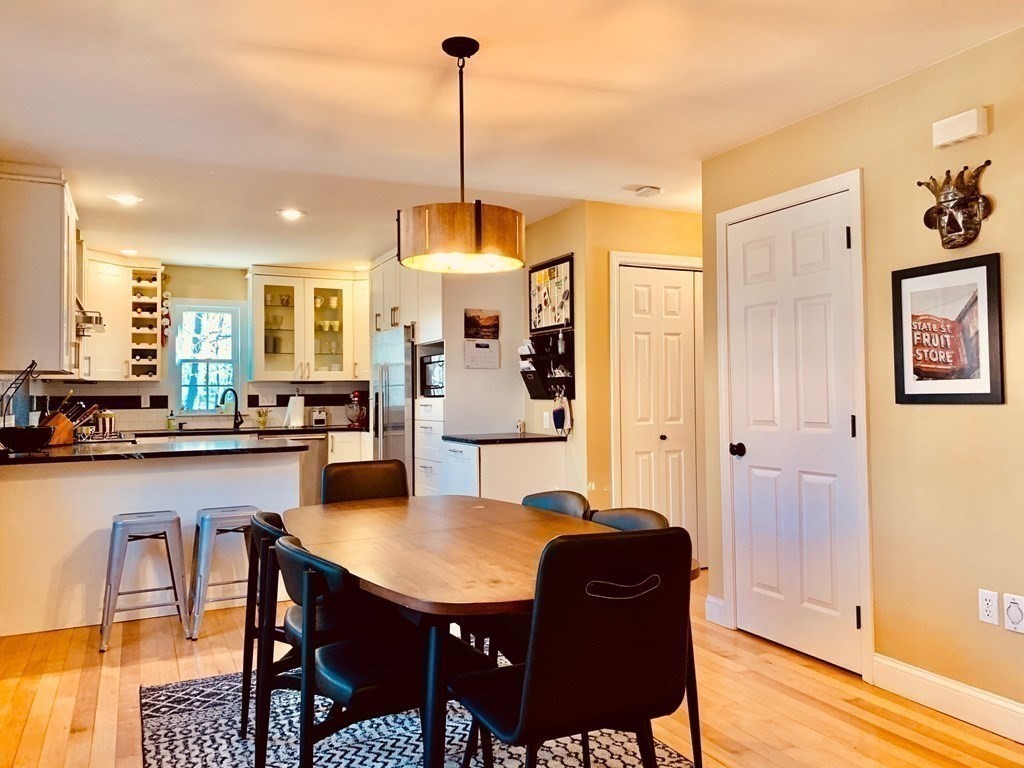 696 Florence Road Northampton, MA 01062 - Photo 8 of 35 a view of a dining room and livingroom with furniture wooden floor a chandelier