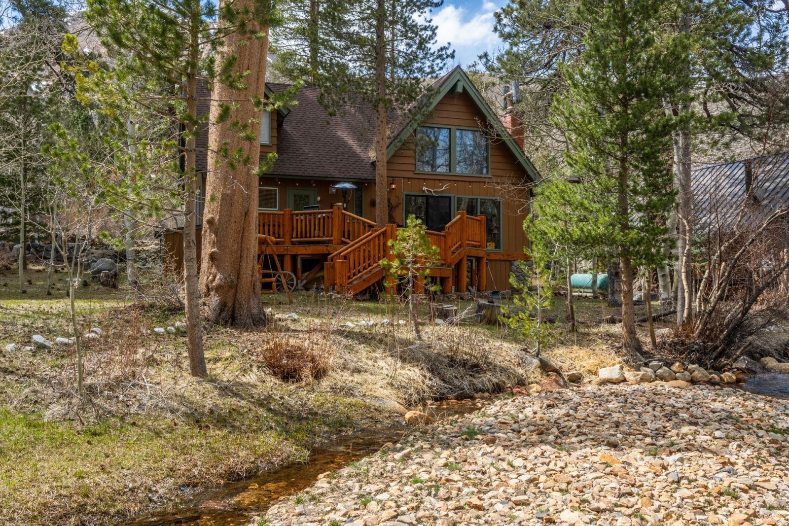 a view of a wooden house with a yard