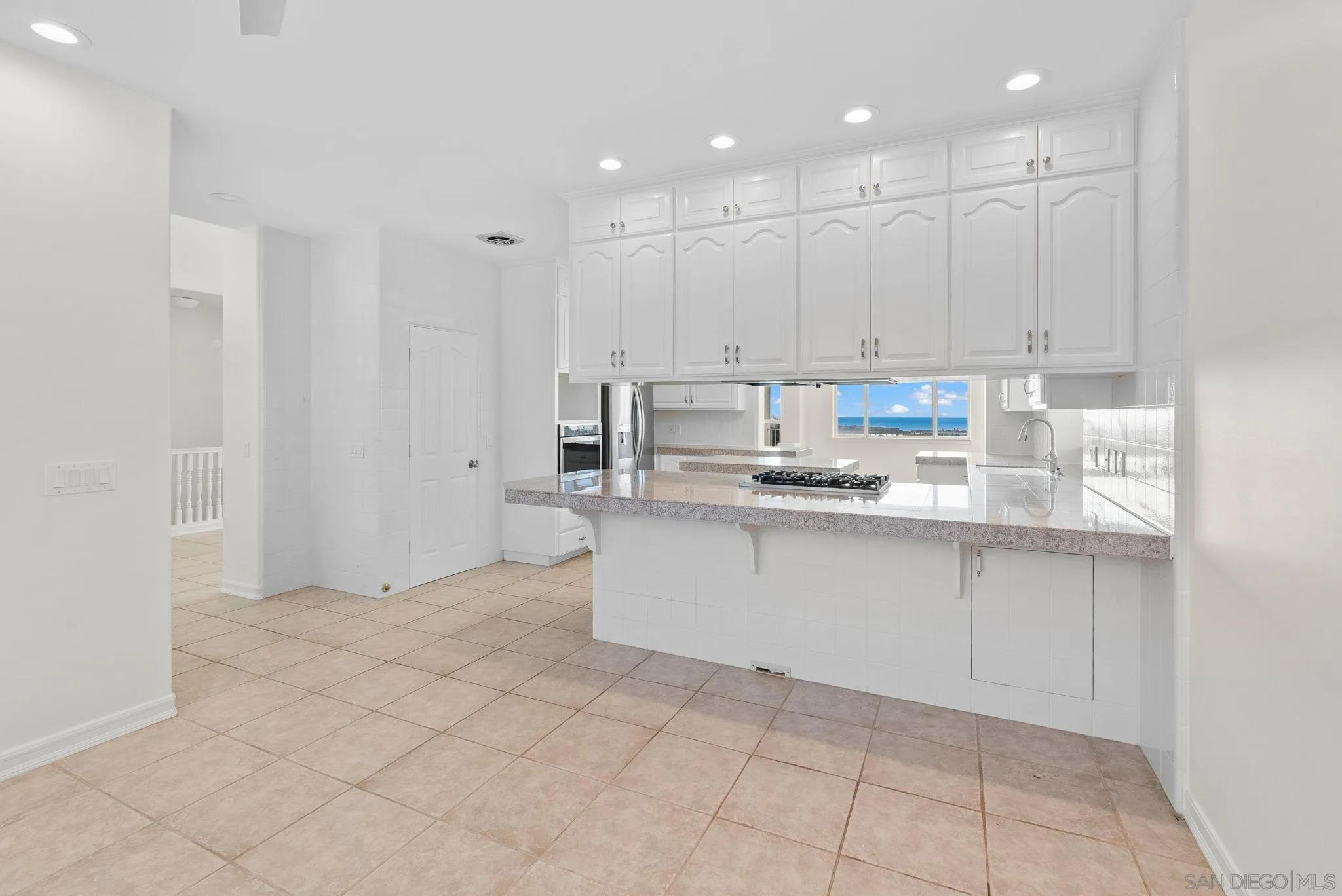 1807 Laurel Road Oceanside, CA 92054 - Photo 29 of 67 a kitchen with white cabinets stainless steel appliances and a sink