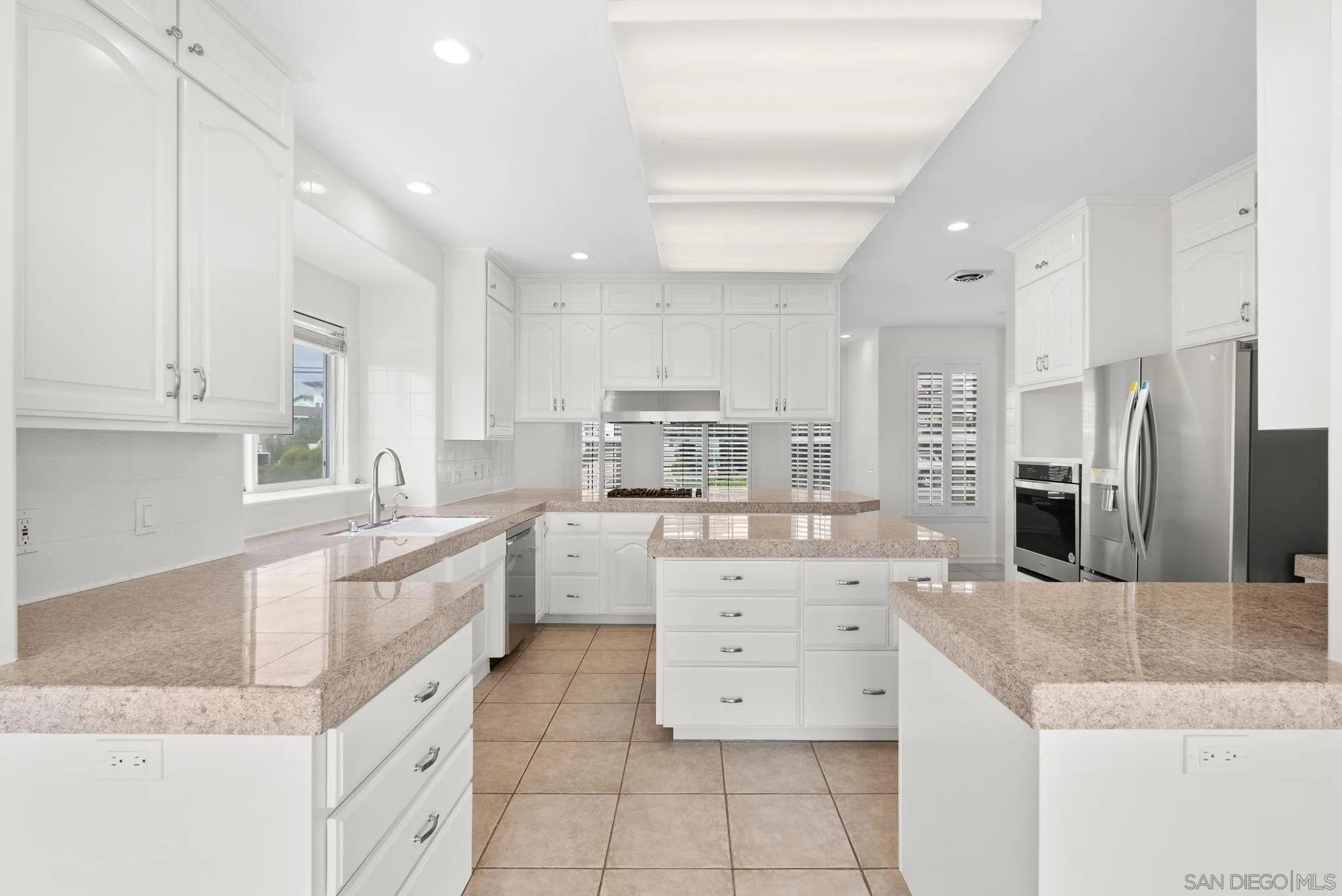 1807 Laurel Road Oceanside, CA 92054 - Photo 31 of 67 a large kitchen with granite countertop a large counter top stainless steel appliances and cabinets