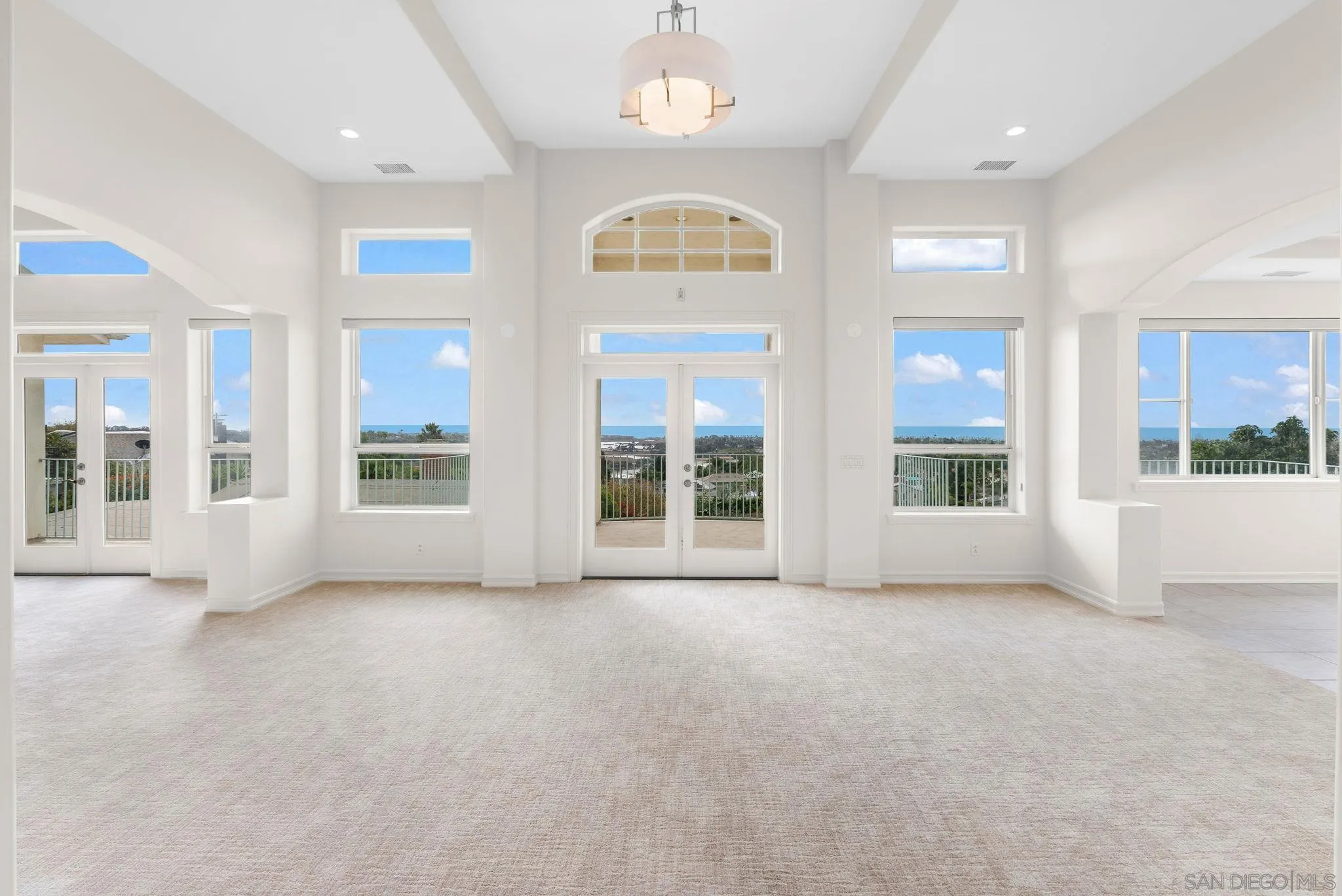 1807 Laurel Road Oceanside, CA 92054 - Photo 34 of 67 an empty room with windows and chandelier