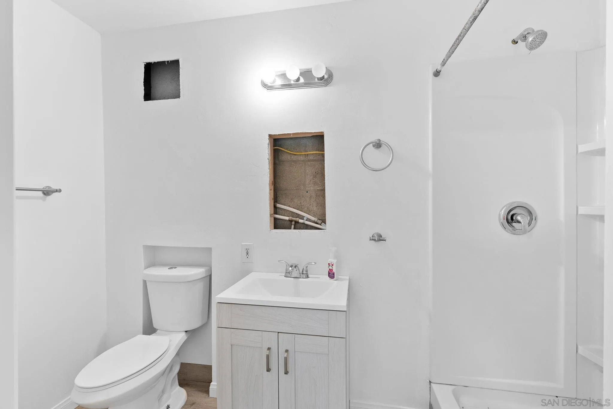 1807 Laurel Road Oceanside, CA 92054 - Photo 64 of 67 a bathroom with a toilet a sink and mirror