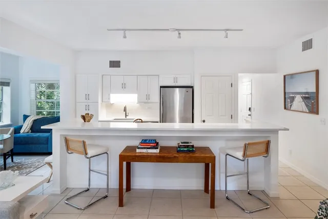 a bathroom with a shower sink and mirror
