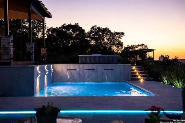 a view of a swimming pool with a seating space