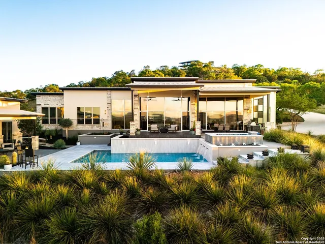 a view of swimming pool with outdoor seating and city view