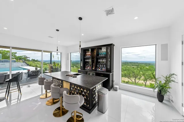a kitchen with a table and chairs next to a large window