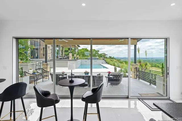a dining room with furniture and floor to ceiling window