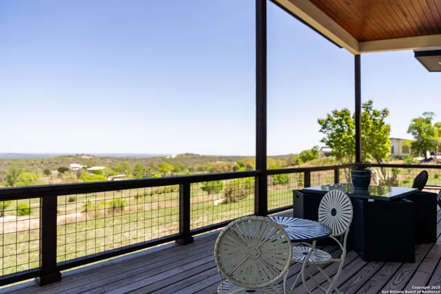 a view of a balcony with lake view and wooden floor