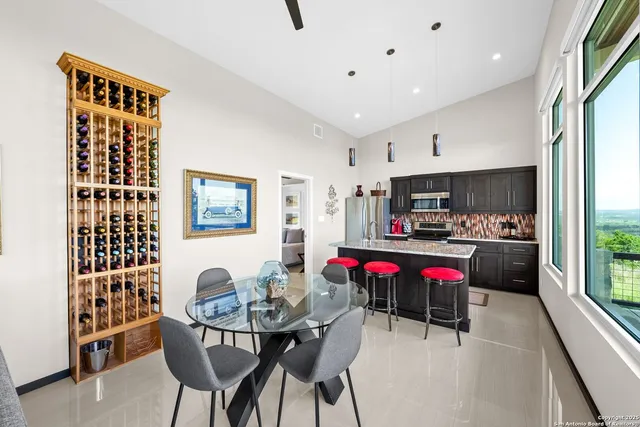 a living room with lots of furniture and kitchen view
