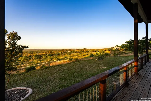 a view of city and ocean from a balcony