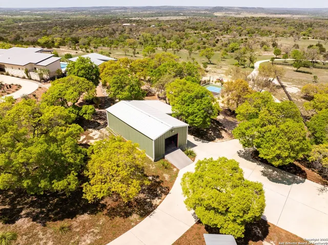 a vase of flowers sitting on a sidewalk