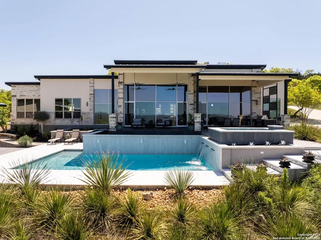 a view of a house and swimming pool with a couches