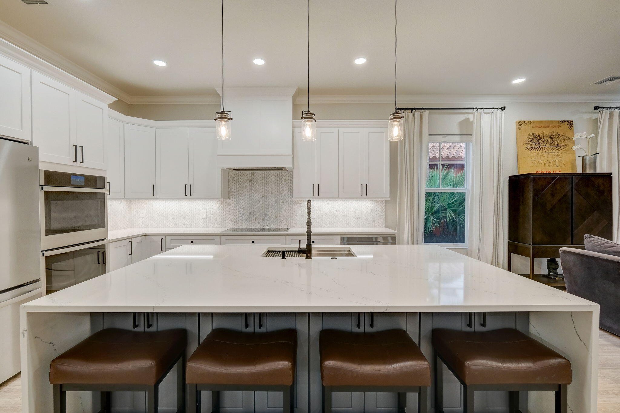 19199 Southeast Daniel Lane Jupiter, FL 33469 - Photo 11 of 49 a kitchen with a table chairs refrigerator and microwave