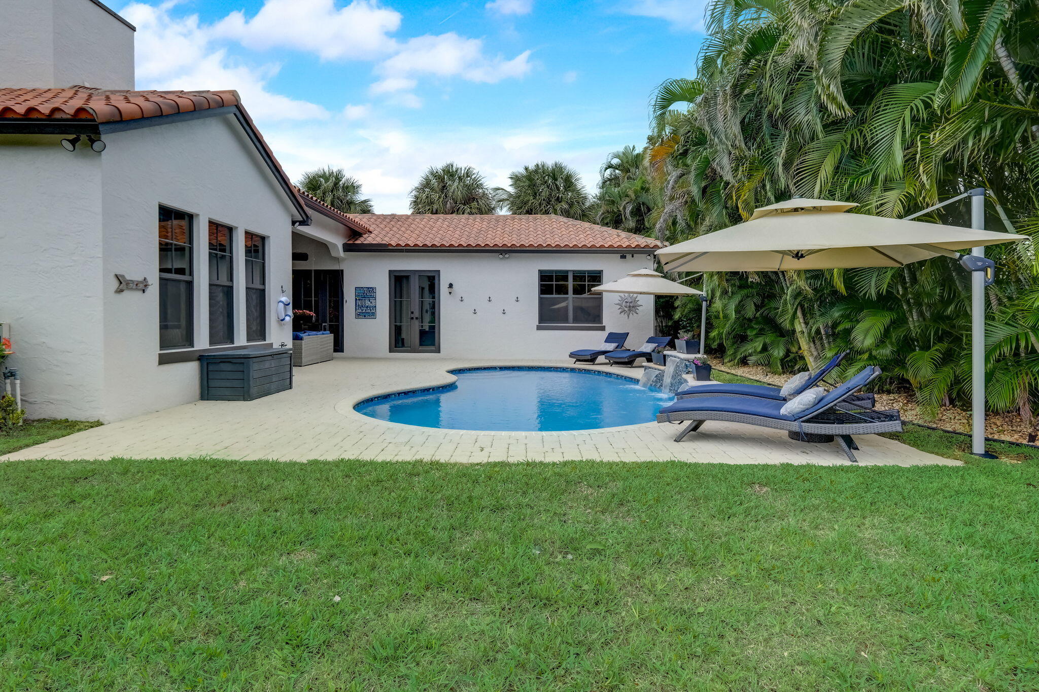 19199 Southeast Daniel Lane Jupiter, FL 33469 - Photo 35 of 49 a view of a house with backyard porch and sitting area