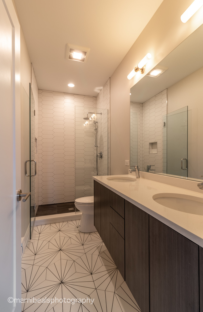 1349 East Marquette Road Chicago, IL 60637 - Photo 14 of 26 a bathroom with a double vanity sink mirror and shower
