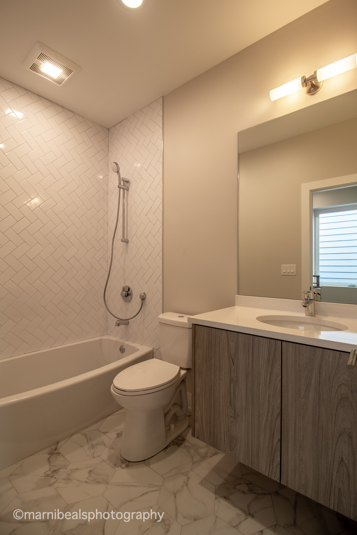 1349 East Marquette Road Chicago, IL 60637 - Photo 15 of 26 a bathroom with a sink toilet and shower