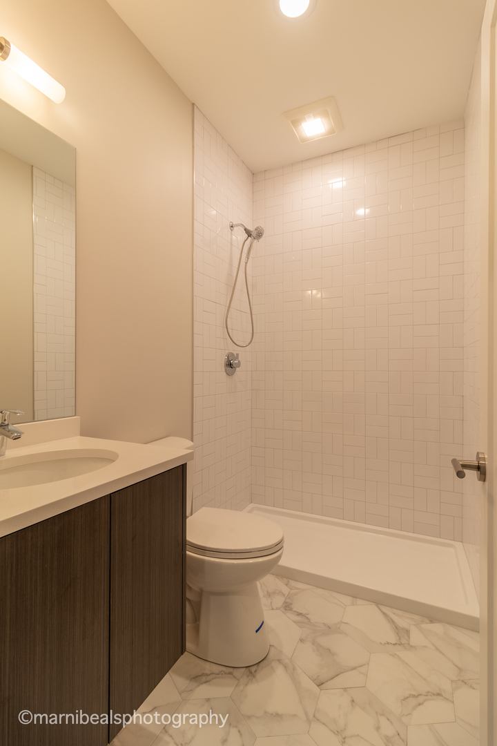 1349 East Marquette Road Chicago, IL 60637 - Photo 18 of 26 a bathroom with a sink a toilet and shower