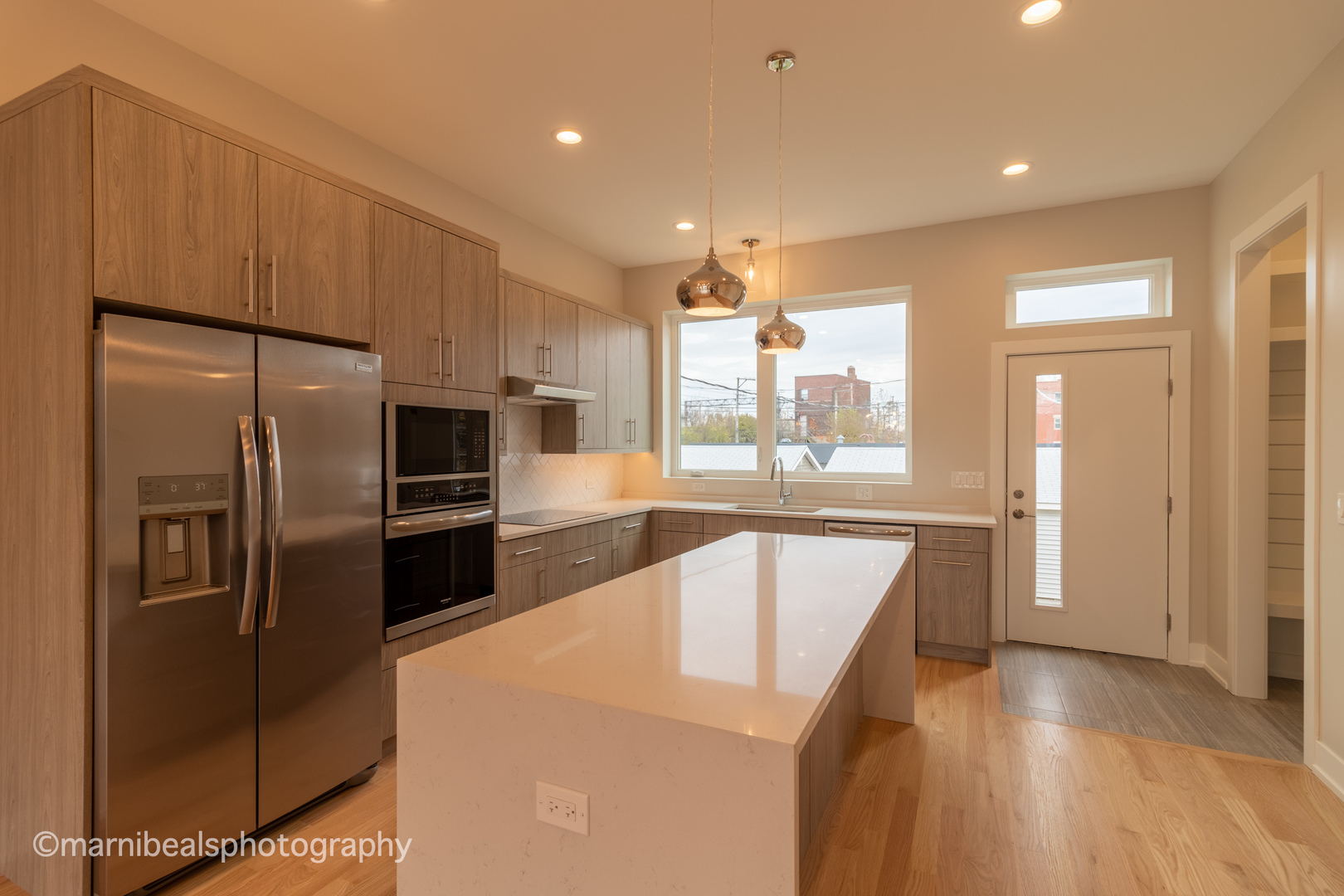 1349 East Marquette Road Chicago, IL 60637 - Photo 5 of 26 a kitchen with stainless steel appliances a refrigerator a sink and wooden cabinets