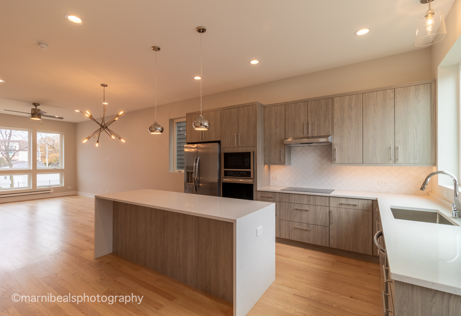 1349 East Marquette Road Chicago, IL 60637 - Photo 6 of 26 a large kitchen with stainless steel appliances a large counter top a sink a refrigerator and a stove