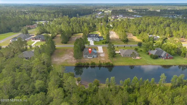an aerial view of residential houses with outdoor space and swimming pool