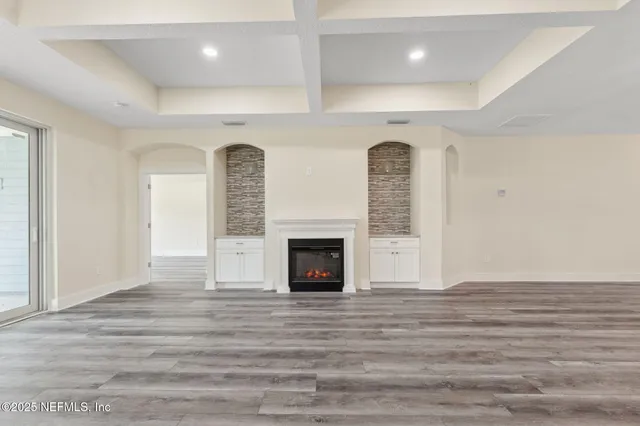 a view of a livingroom with a fireplace and window
