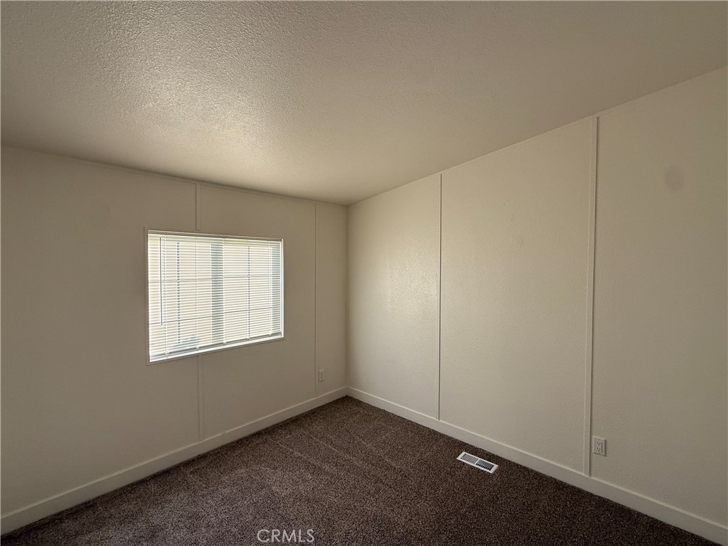 7850 Slater Avenue, Unit 99 Huntington Beach, CA 92647 - Photo 11 of 16 an empty room with windows