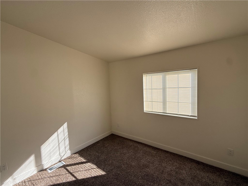 7850 Slater Avenue, Unit 99 Huntington Beach, CA 92647 - Photo 10 of 16 an empty room with a window