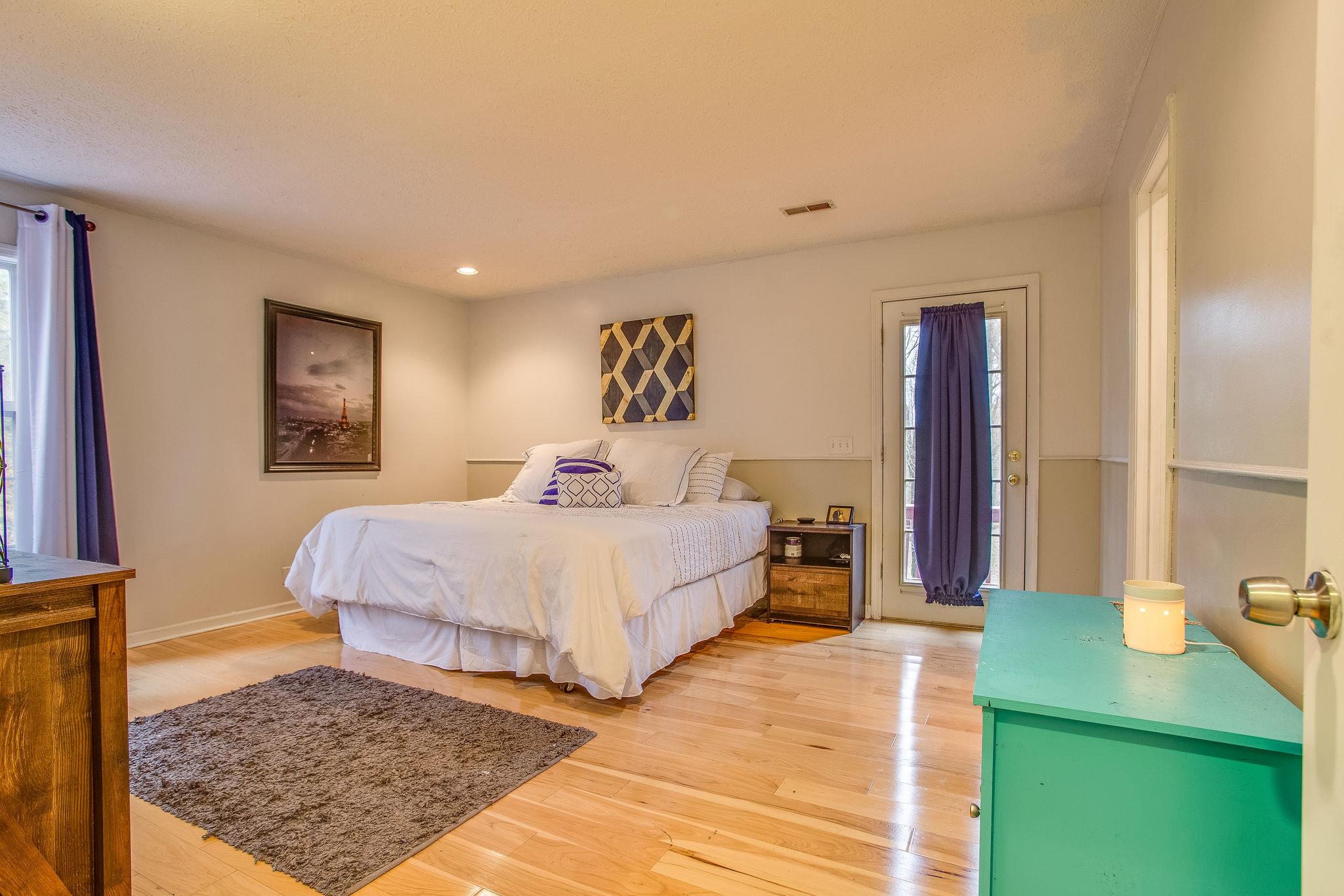 2133 Lee Road Spring Hill, TN 37174 - Photo 9 of 30 a bedroom with a bed and a table in it