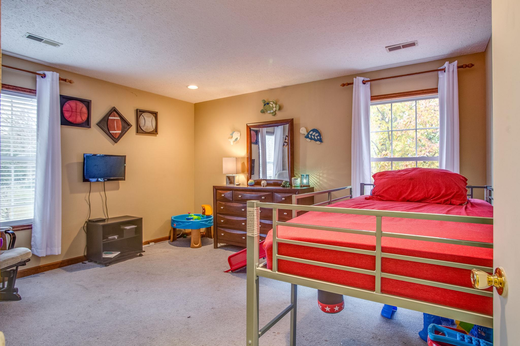 2133 Lee Road Spring Hill, TN 37174 - Photo 13 of 30 a bedroom with a bed and a flat screen tv