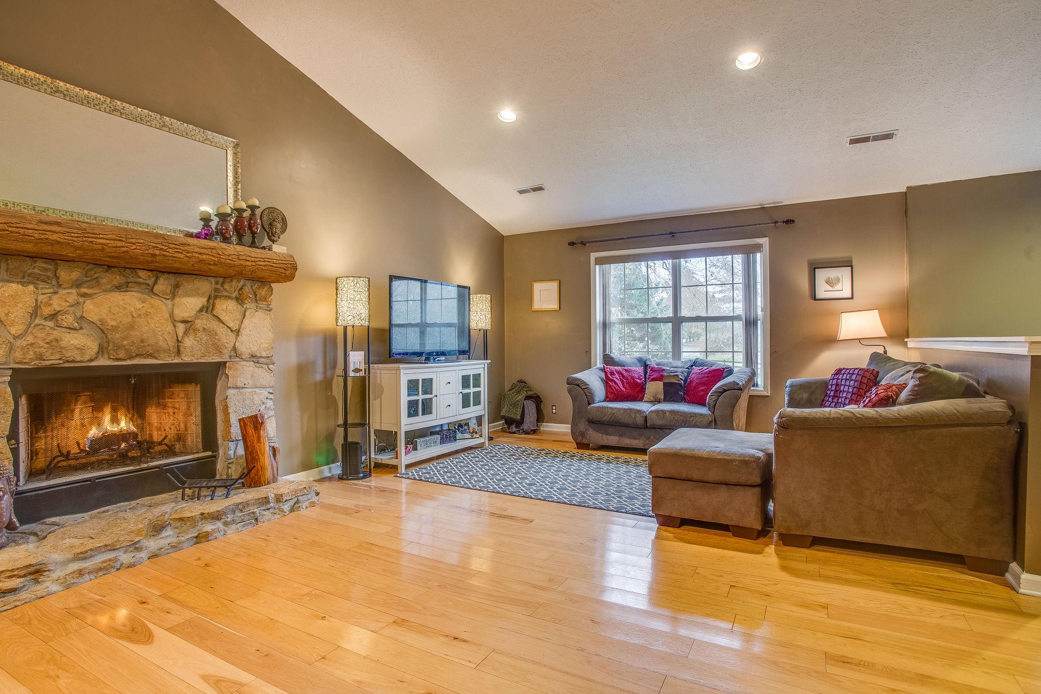 2133 Lee Road Spring Hill, TN 37174 - Photo 4 of 30 a living room with furniture and a fireplace