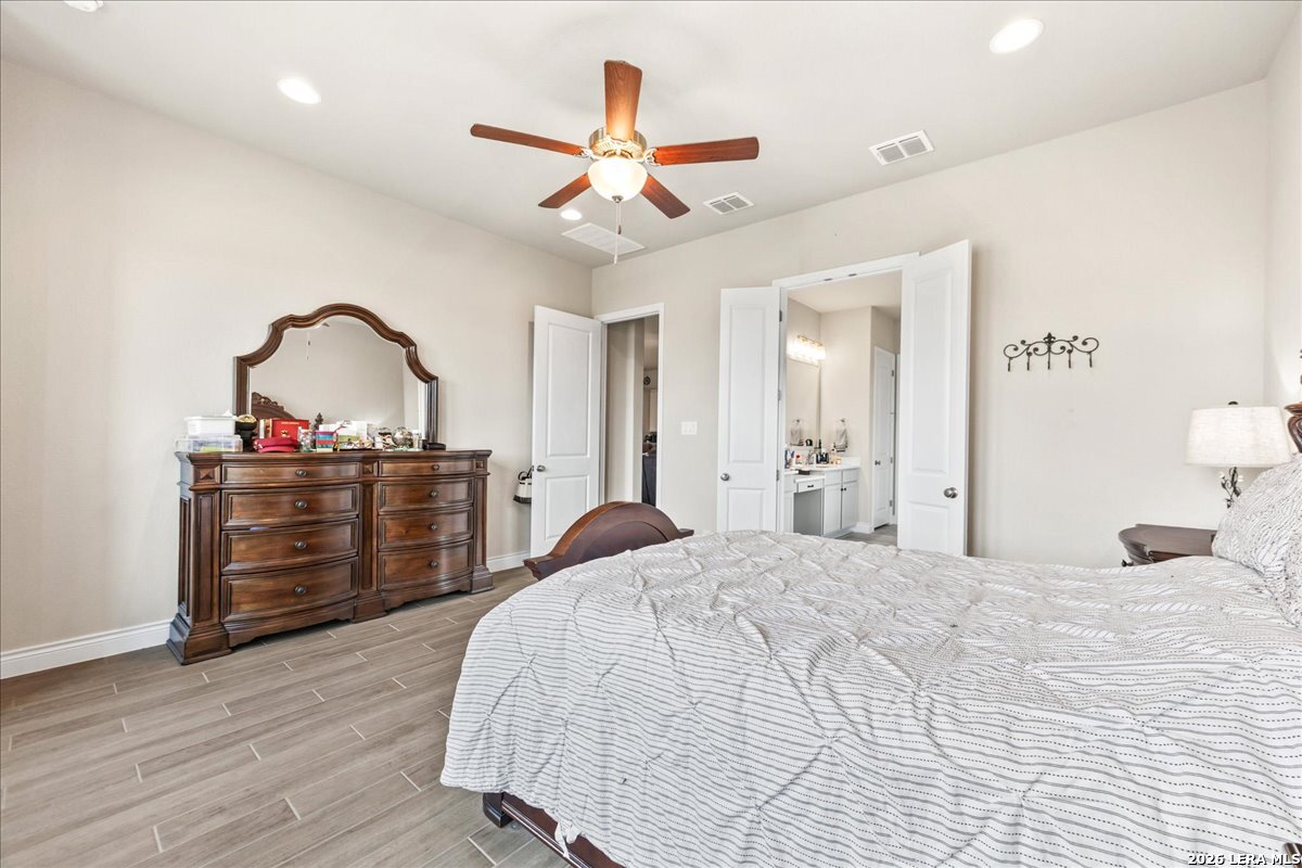 3034 Agar Bulverde, TX 78163 - Photo 20 of 33 a bedroom with a bed and a chandelier