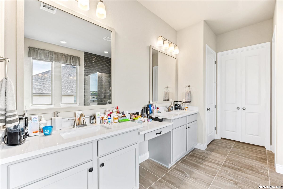 3034 Agar Bulverde, TX 78163 - Photo 21 of 33 a bathroom with double sink and a mirror