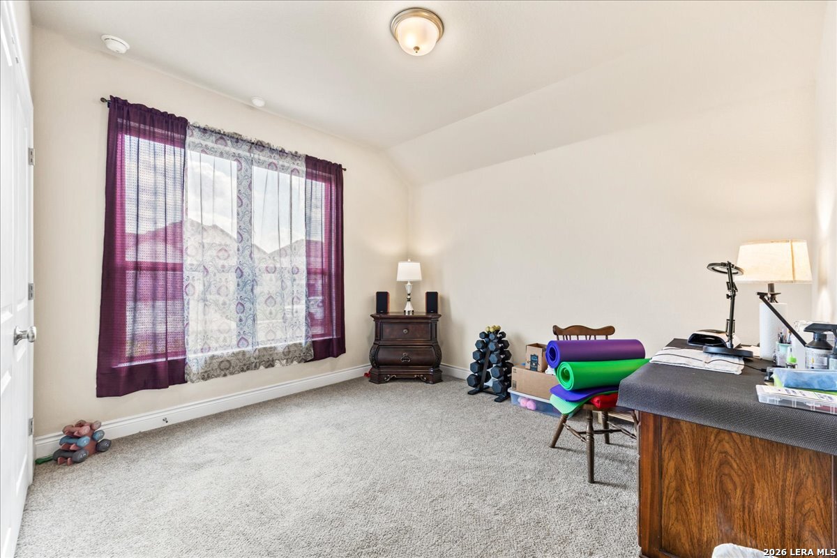 3034 Agar Bulverde, TX 78163 - Photo 23 of 33 a living room with furniture gym equipment and a large window