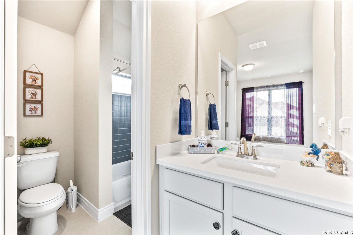 3034 Agar Bulverde, TX 78163 - Photo 24 of 33 a bathroom with a double vanity sink toilet and a mirror