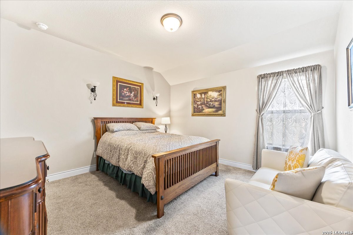 3034 Agar Bulverde, TX 78163 - Photo 8 of 33 a spacious bedroom with a bed and a couch